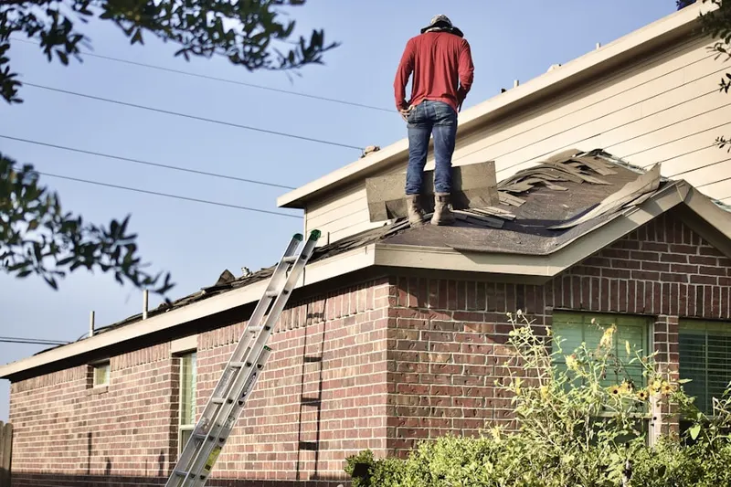 Professional roofer working on a residential roof in Bridgehampton